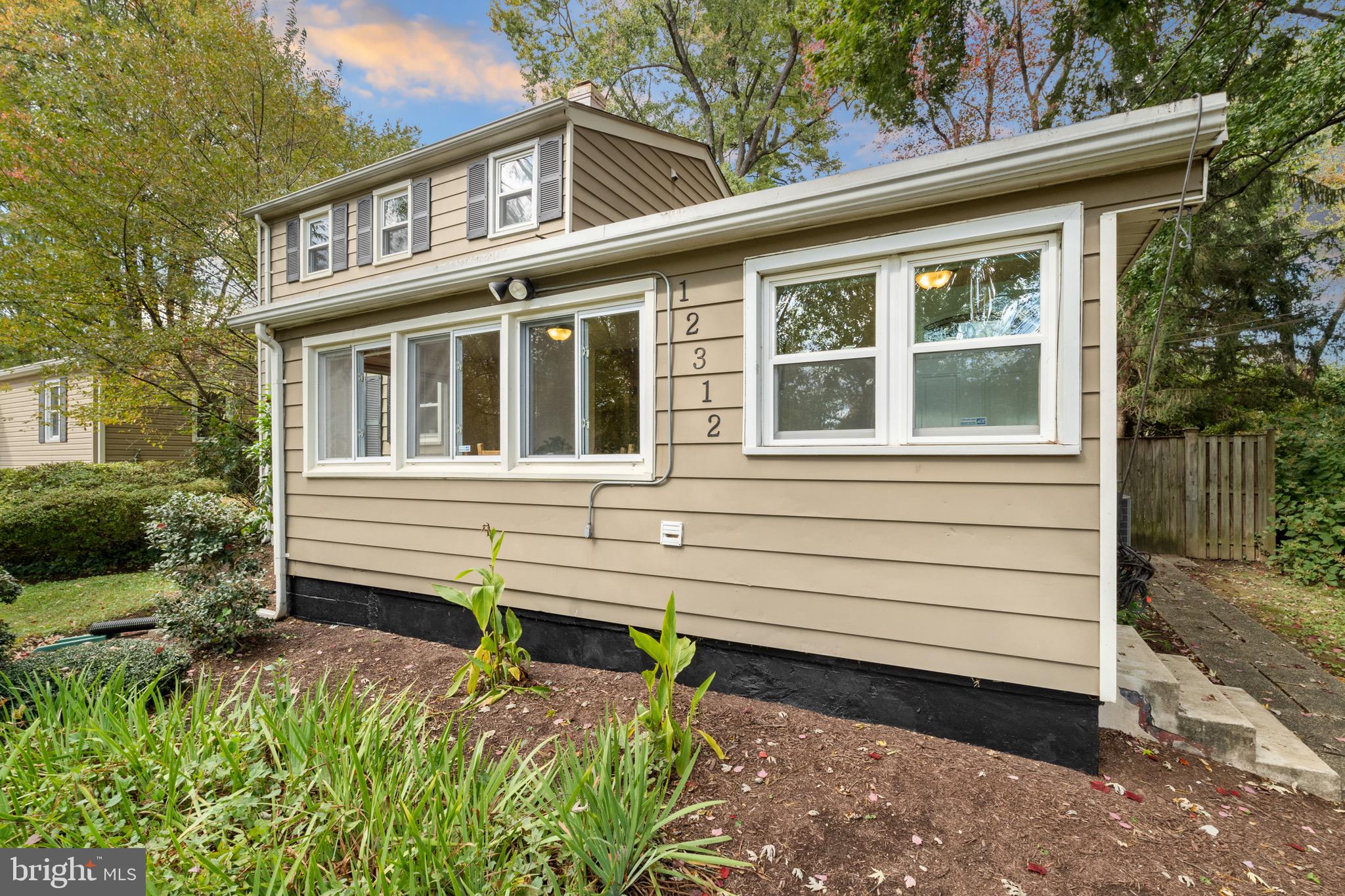 12312 Valleywood Drive Silver Spring, MD 20902 - Photo 41 of 65 a front view of a house with a garden