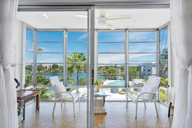 a living room with a floor to ceiling window and wooden floor