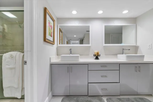 a bathroom with a double vanity sink mirror and