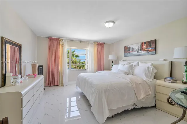 a spacious bedroom with a bed a couch and a window