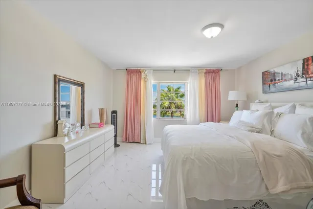 a spacious bedroom with a bed and a couch