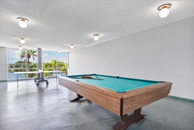 a room with pool tables and windows