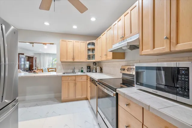 a kitchen with stainless steel appliances granite countertop a stove and a sink