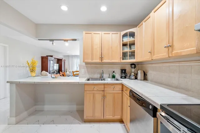 a kitchen with a sink cabinets and window
