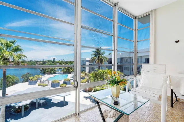 a dining room with furniture and a potted plant