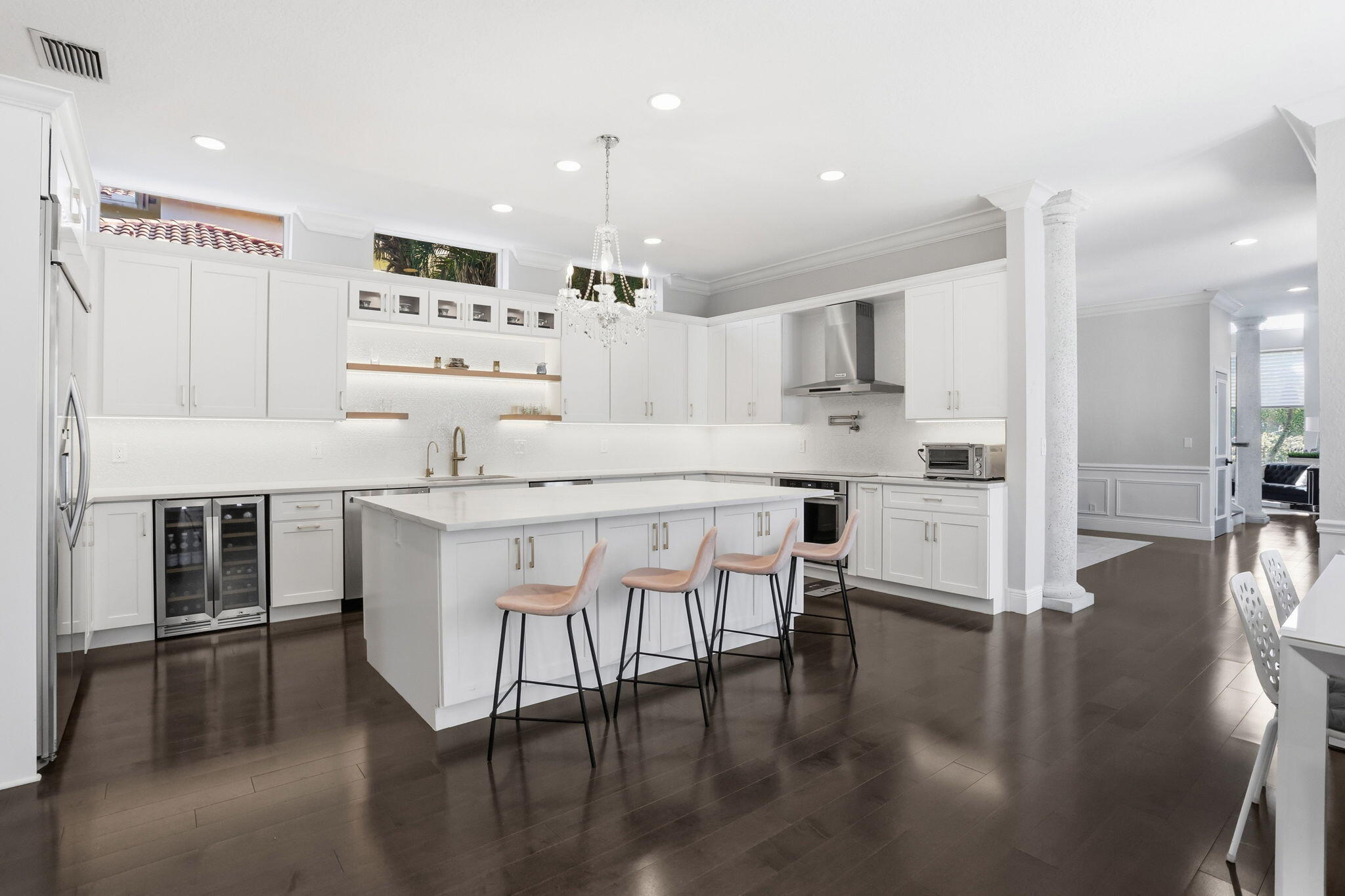 375 Southwest 16th Street Boca Raton, FL 33432 - Photo 12 of 42 a kitchen with stainless steel appliances kitchen island granite countertop a table chairs refrigerator and sink
