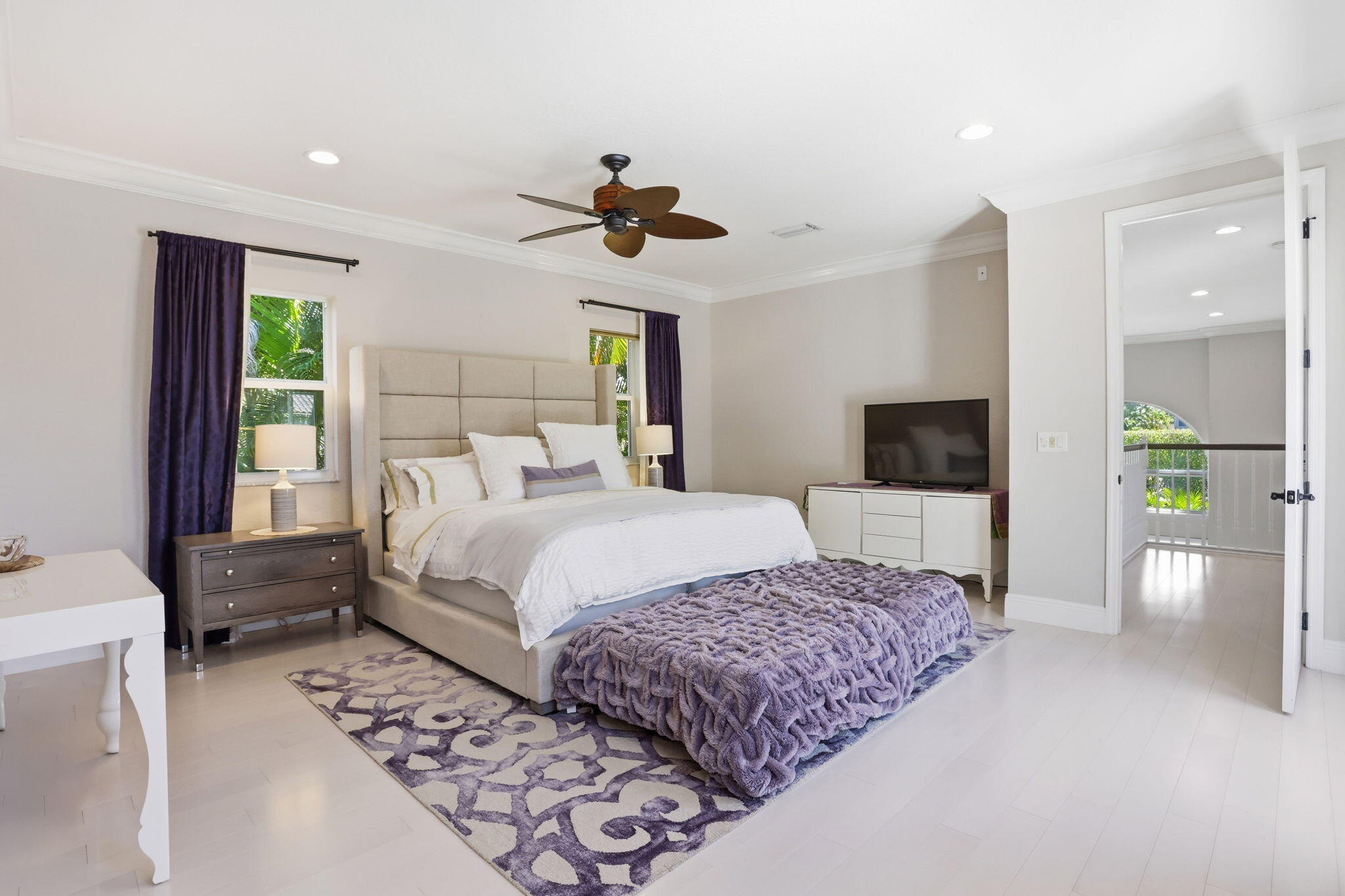 375 Southwest 16th Street Boca Raton, FL 33432 - Photo 19 of 42 a bedroom with a large bed and a chandelier