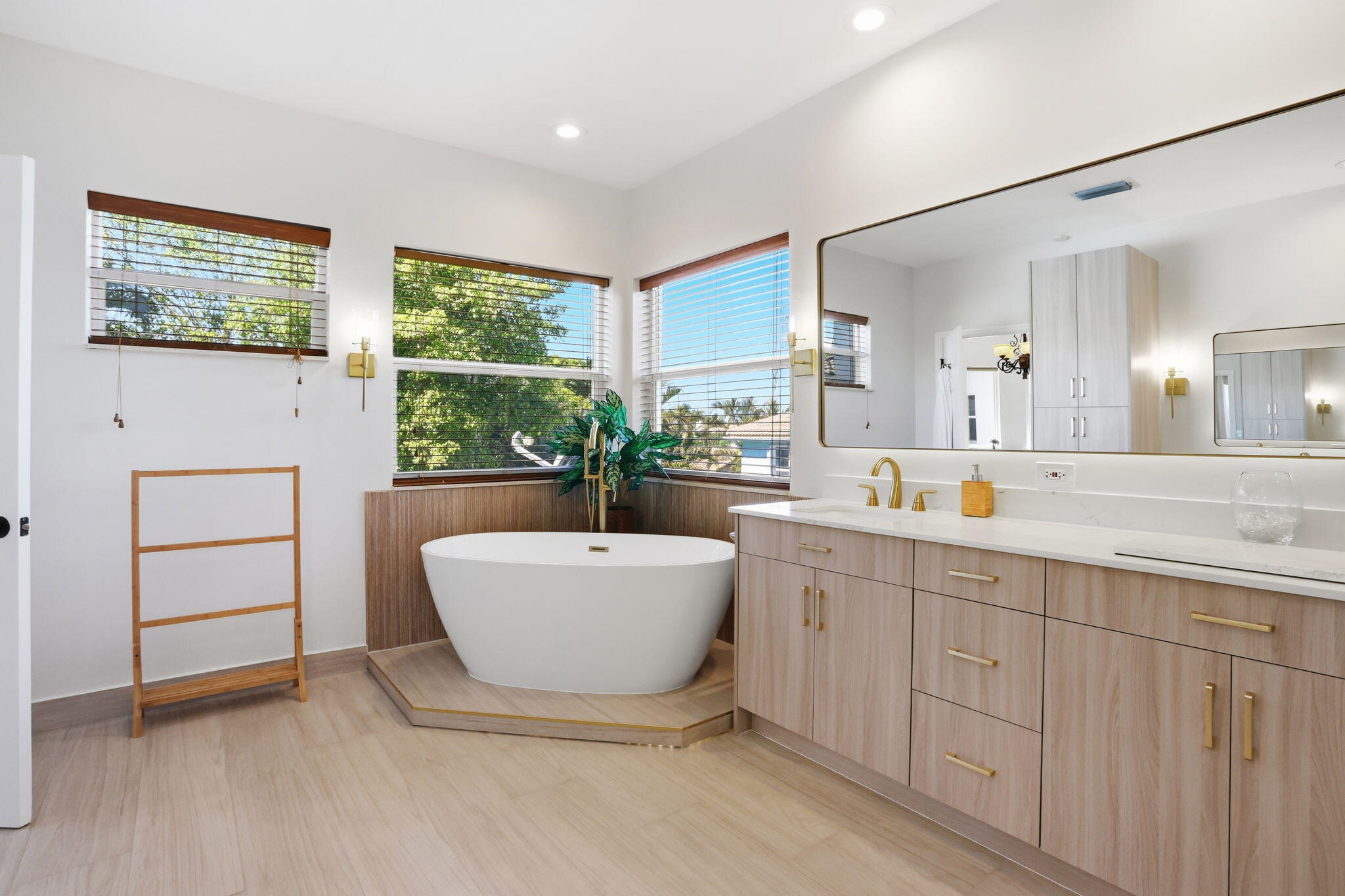 375 Southwest 16th Street Boca Raton, FL 33432 - Photo 23 of 42 a spacious bathroom with a double vanity sink a mirror and a bathtub