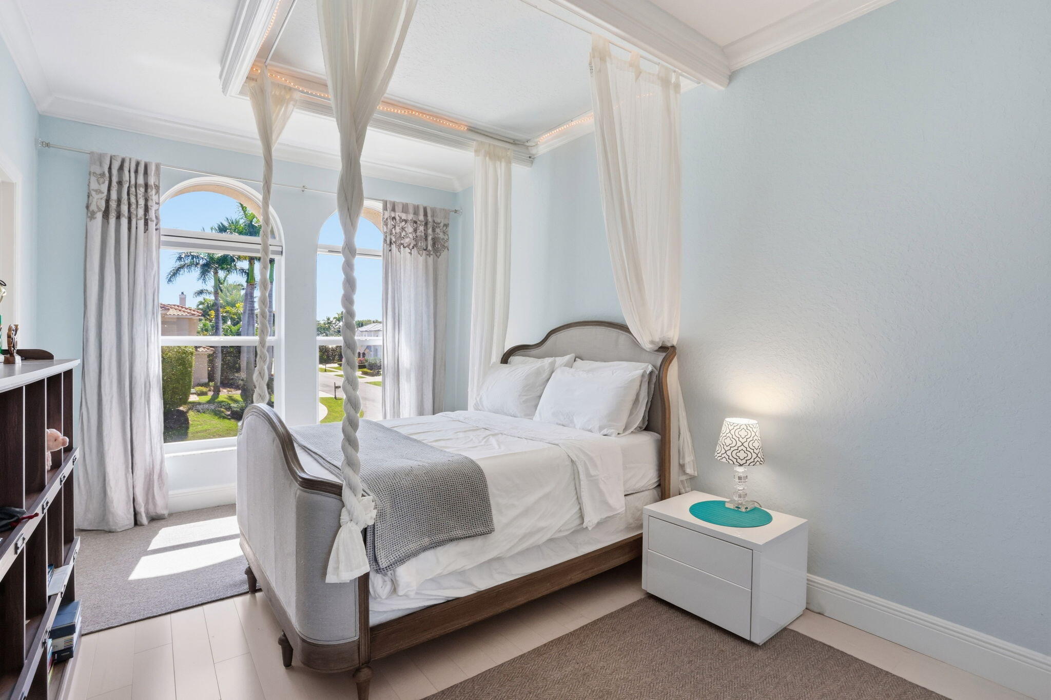 375 Southwest 16th Street Boca Raton, FL 33432 - Photo 26 of 42 a bedroom with a bed lamp and a large window