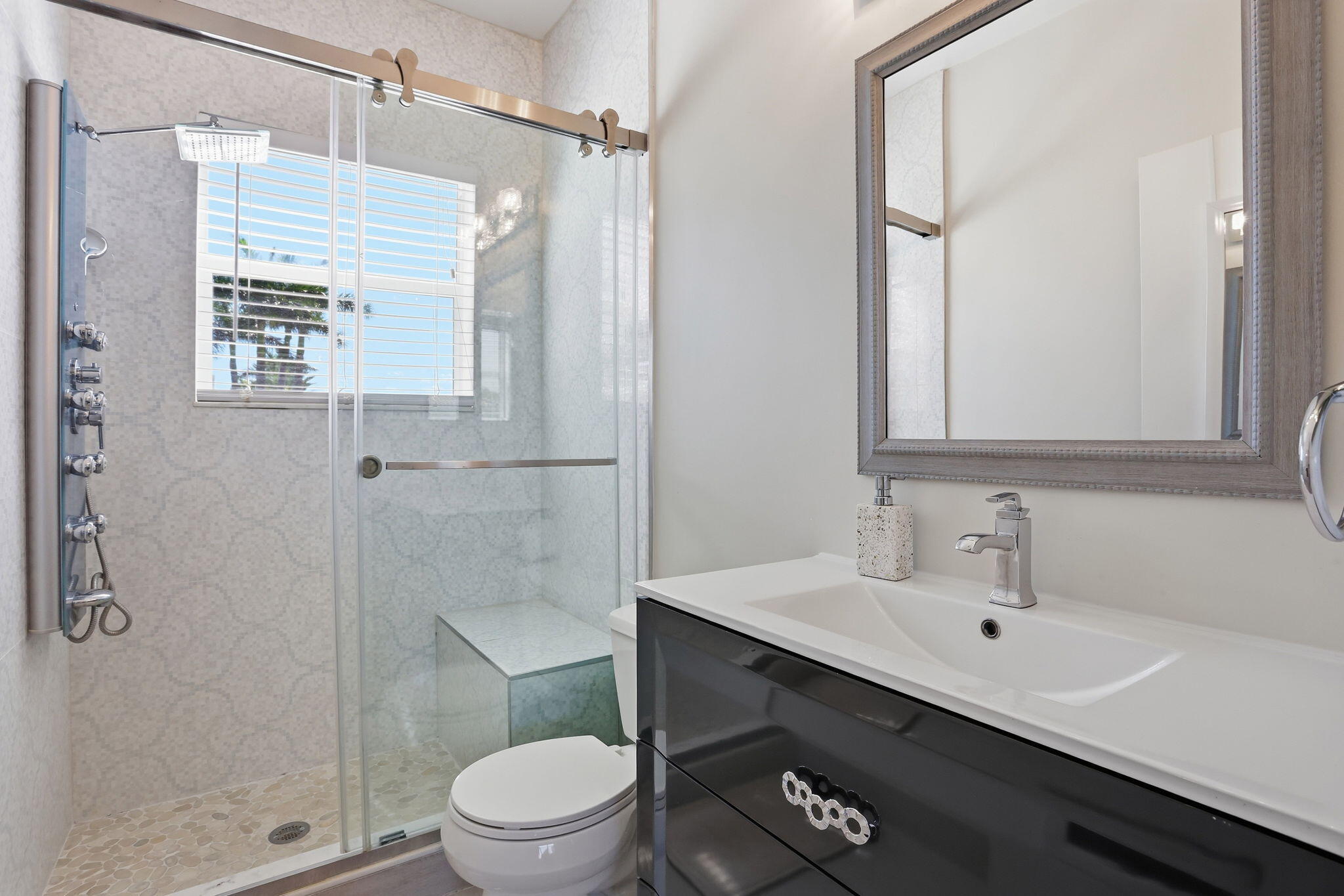 375 Southwest 16th Street Boca Raton, FL 33432 - Photo 27 of 42 a bathroom with a sink a toilet and shower