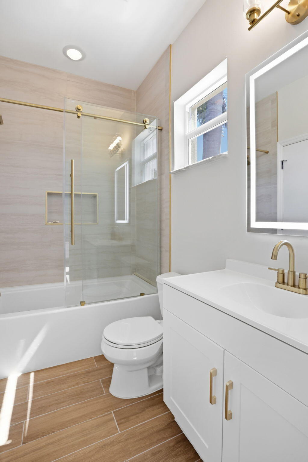 375 Southwest 16th Street Boca Raton, FL 33432 - Photo 29 of 42 a bathroom with a sink toilet vanity and shower