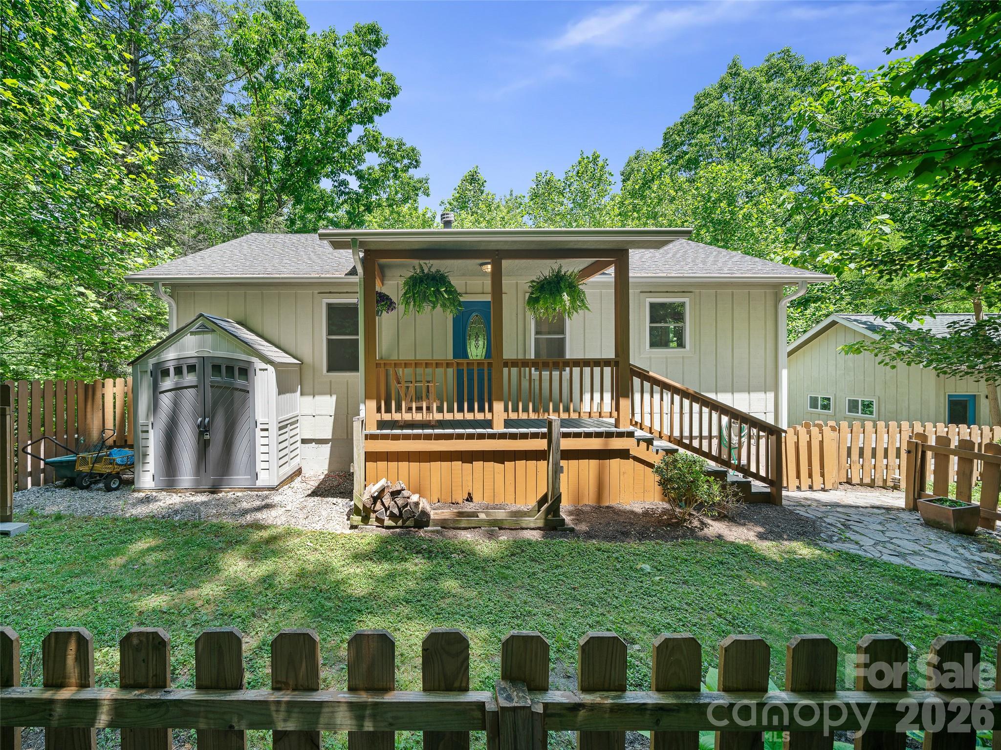 142 Wildflower Road Spruce Pine, NC 28777 - Photo 2 of 46 a view of a house with a wooden deck and a yard