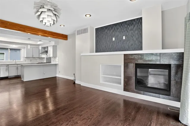 a kitchen with kitchen island granite countertop a sink cabinets and stainless steel appliances