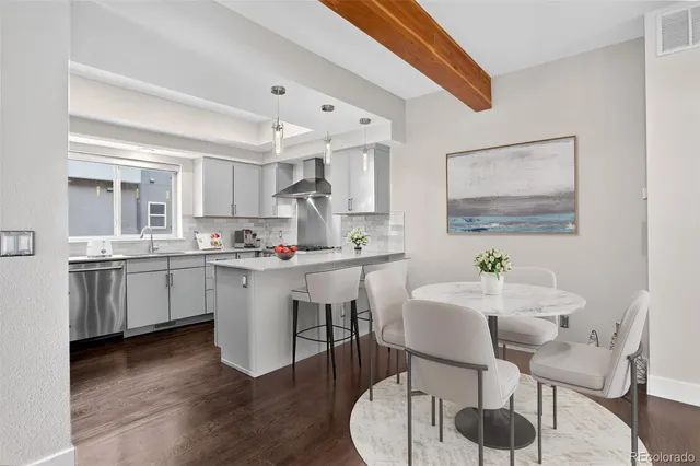 a kitchen with a sink cabinets and wooden floor