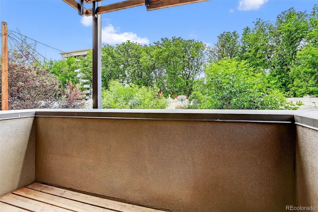 a view of a chairs and table in the balcony
