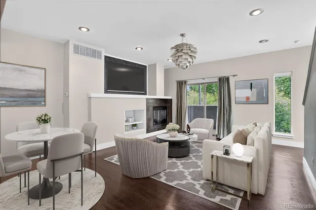 a living room with fireplace furniture and a flat screen tv