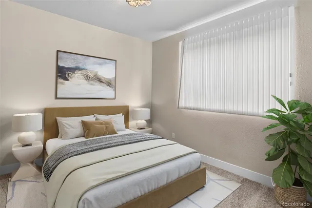 a bedroom with a bed and a potted plant