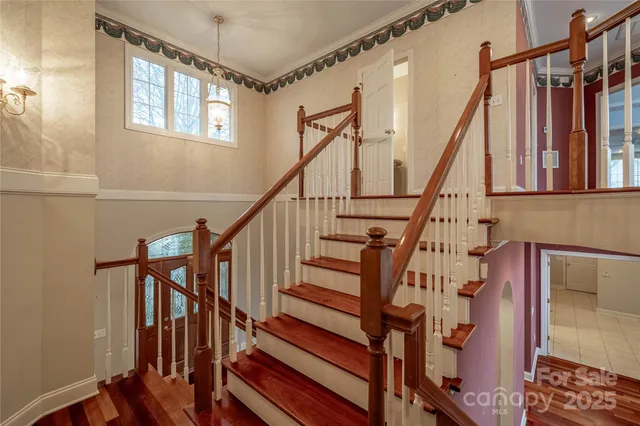 a view of entryway with wooden floor and stairs