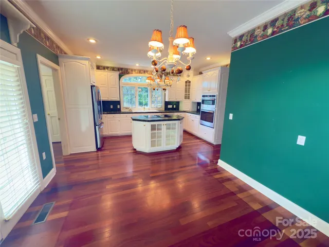 a view of a kitchen with wooden floor