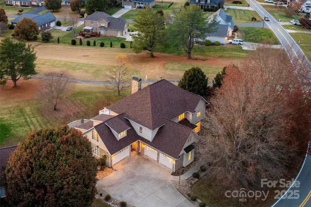 an aerial view of house with yard swimming pool and outdoor seating