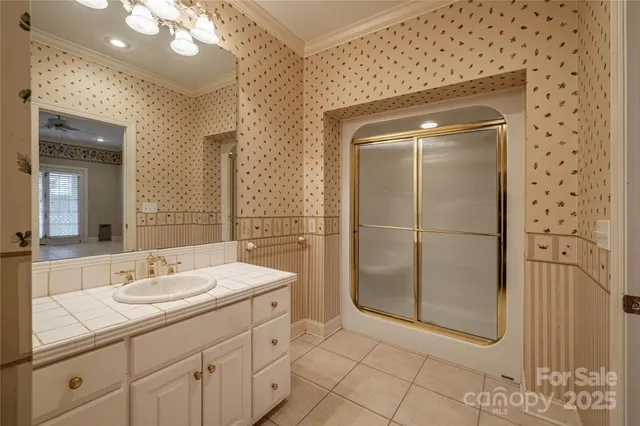 a bathroom with a shower a mirror and a sink