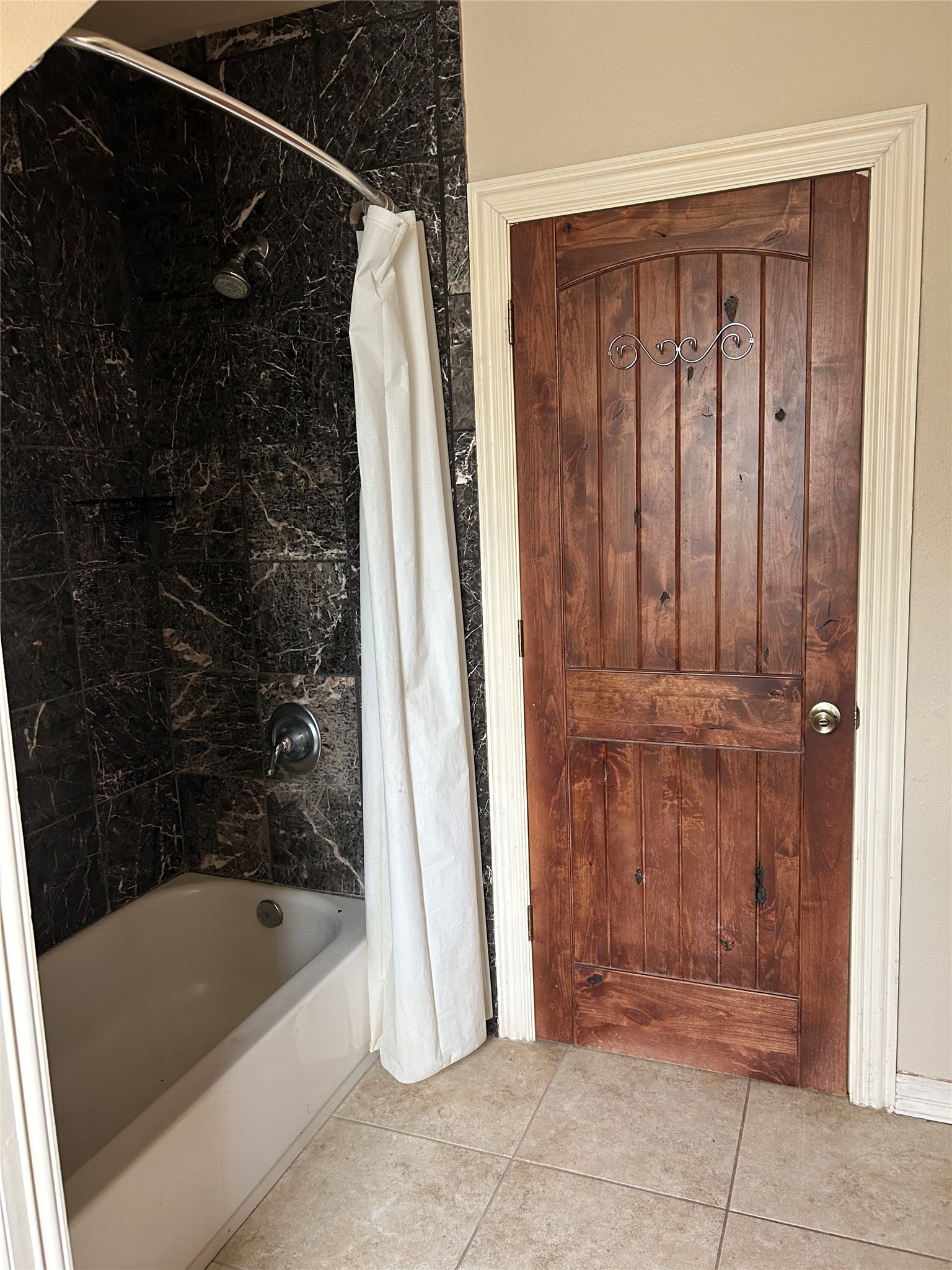 329 Flash Circle Luling, TX 78648 - Photo 28 of 32 Rich wood tones and dark tile details elevate this classic bathroom design.
