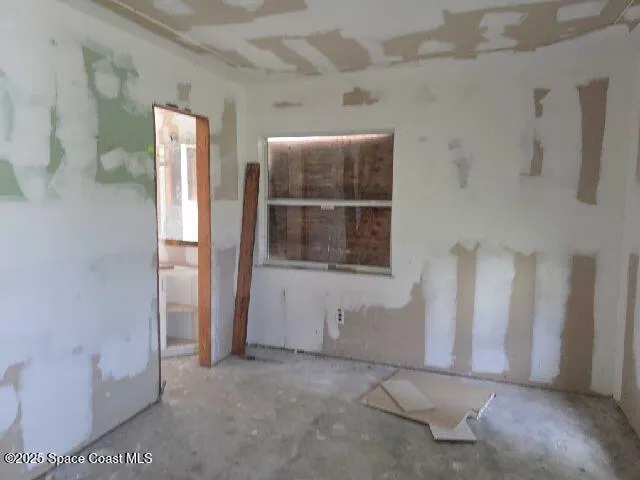 a view of an empty room with windows