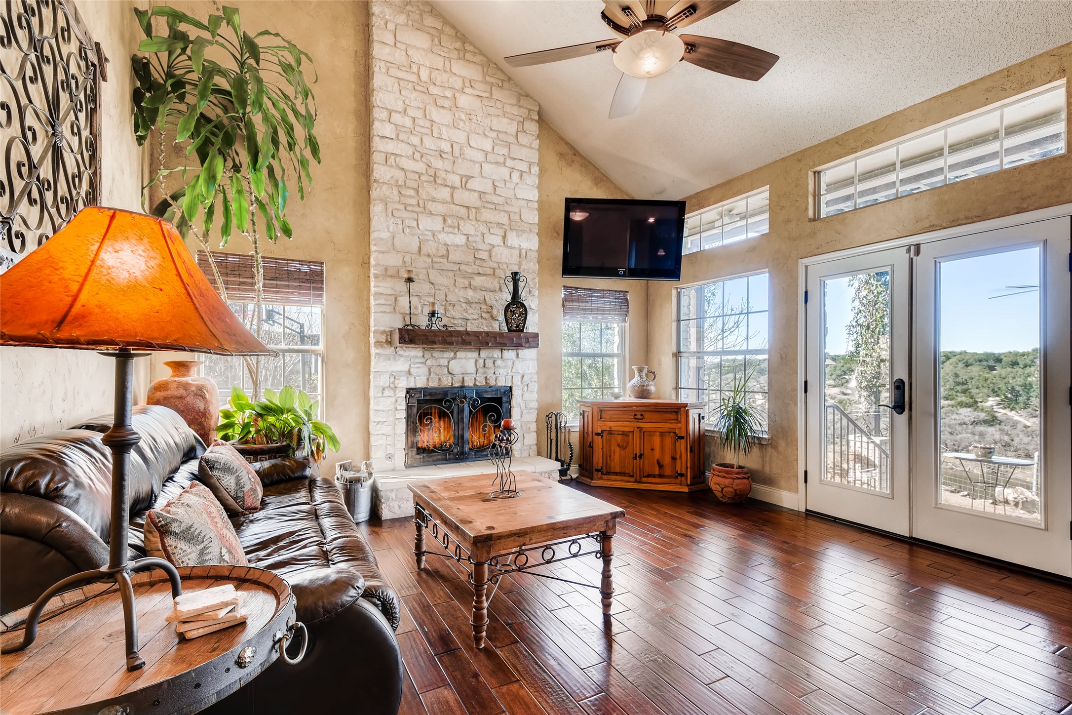 2614 Pace Bend Road South Spicewood, TX 78669 - Photo 8 of 26 Living room area with wood burning fireplace.
*not current furniture in home*