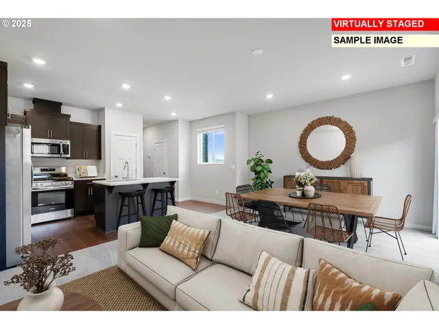 a living room with furniture and kitchen view