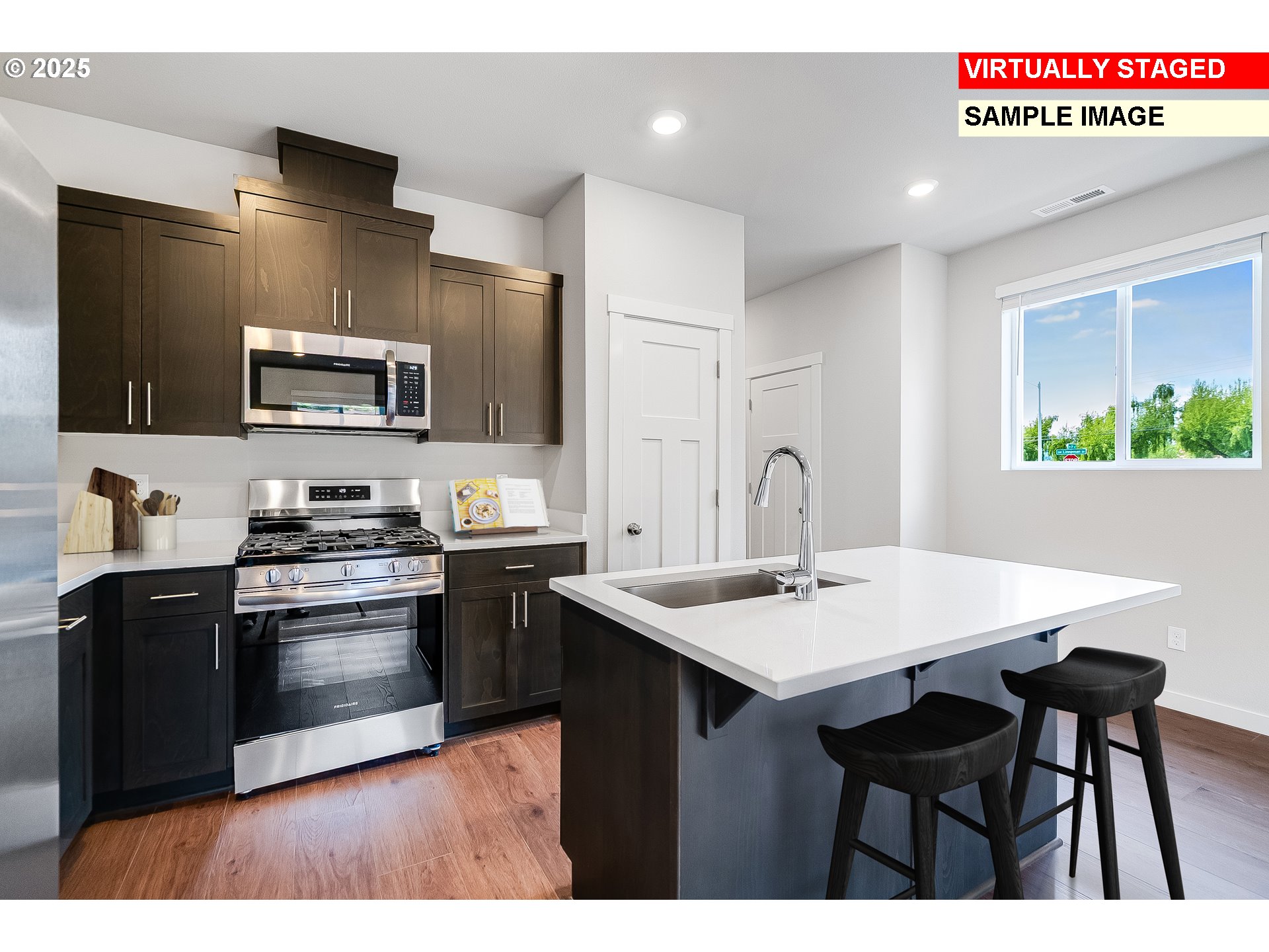 16586 Southwest Darling Lane Tigard, OR 97224 - Photo 6 of 25 a kitchen with stainless steel appliances a stove a sink a microwave a refrigerator and white cabinets
