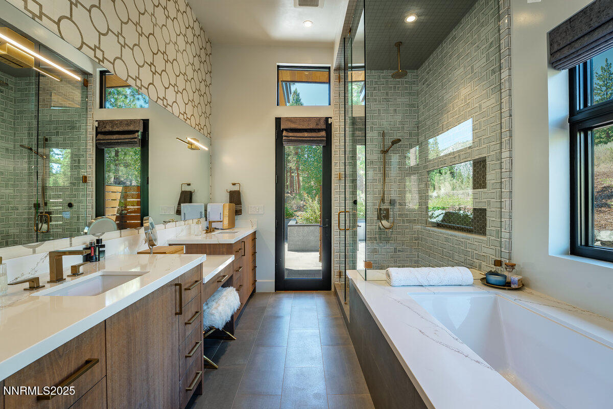 181 Redding Way Carson City, NV 89705 - Photo 20 of 40 a bathroom with a tub a double vanity sink shower and mirror