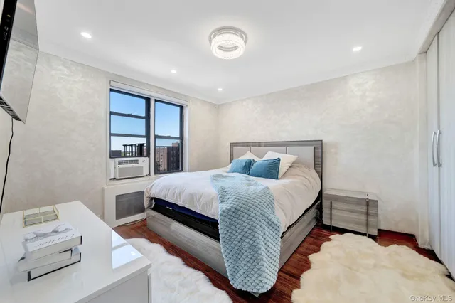 a spacious bedroom with a bed and a cabinets