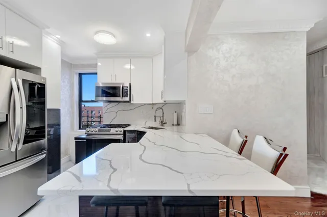 a kitchen with a table chairs microwave and refrigerator