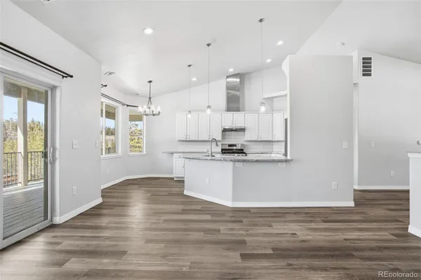 a view of kitchen with wooden floor and window