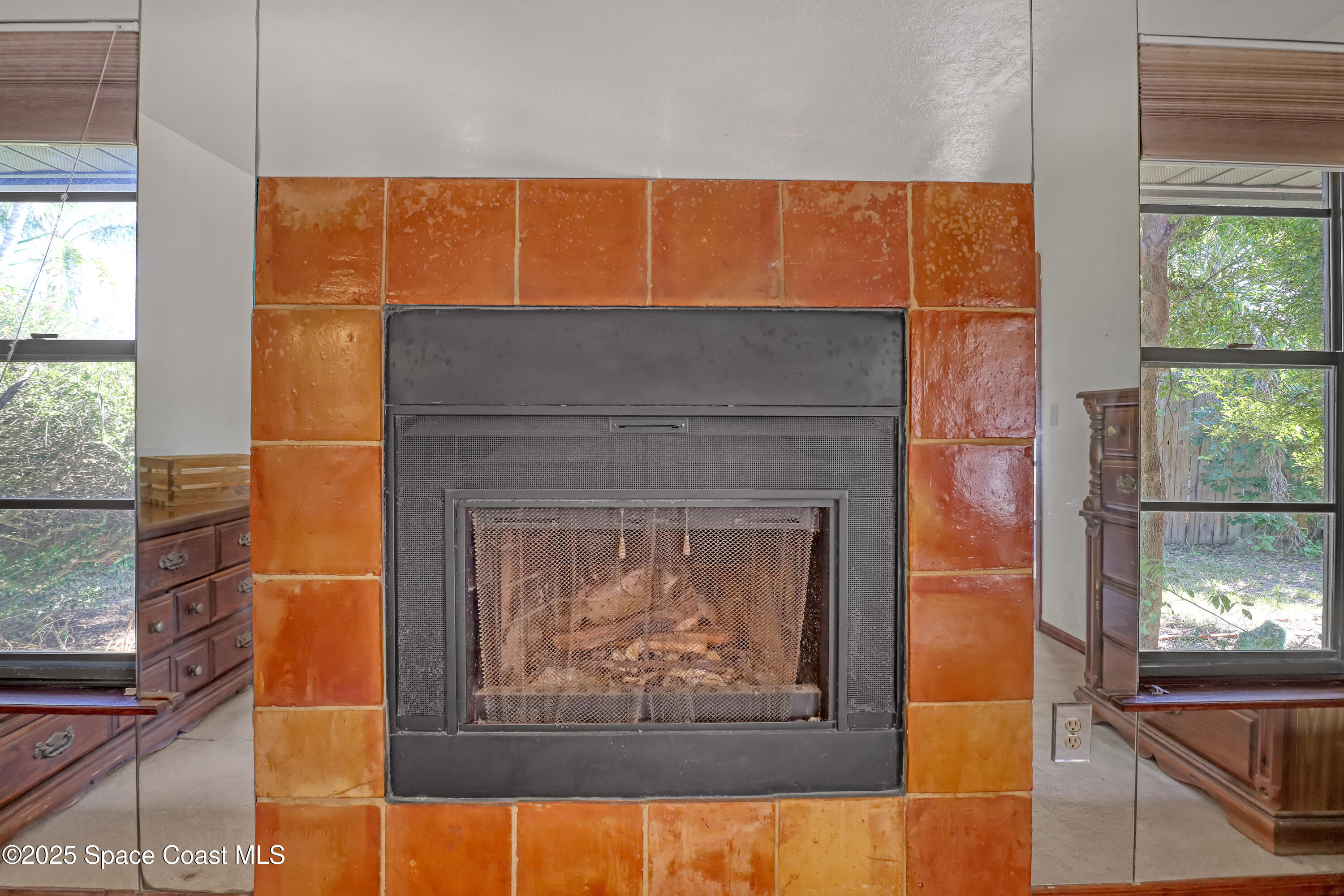 235 Sand Dollar Road Indialantic, FL 32903 - Photo 12 of 64 a fireplace with a painting on the wall