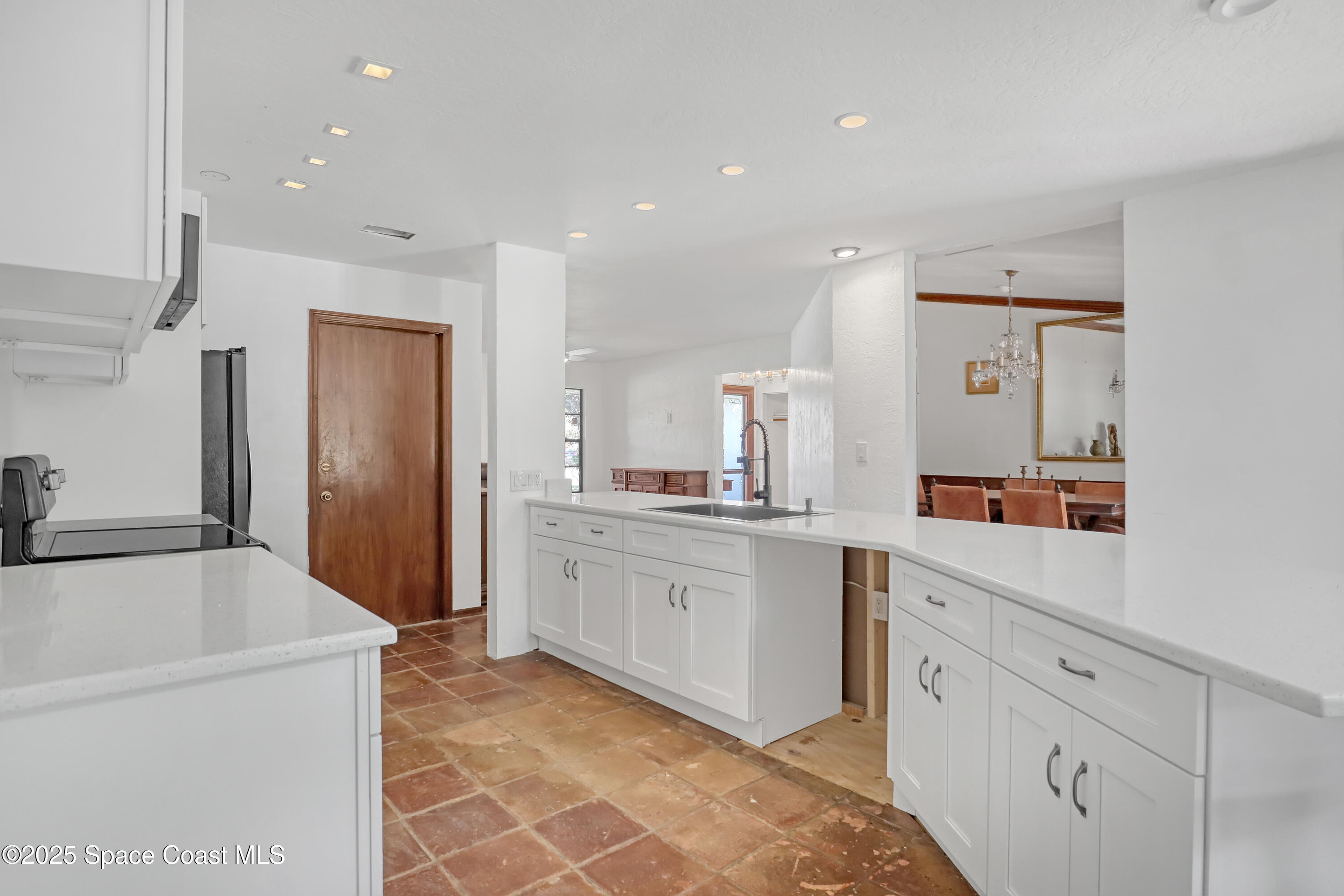 235 Sand Dollar Road Indialantic, FL 32903 - Photo 23 of 64 a large kitchen with a sink and dishwasher a refrigerator with white cabinets