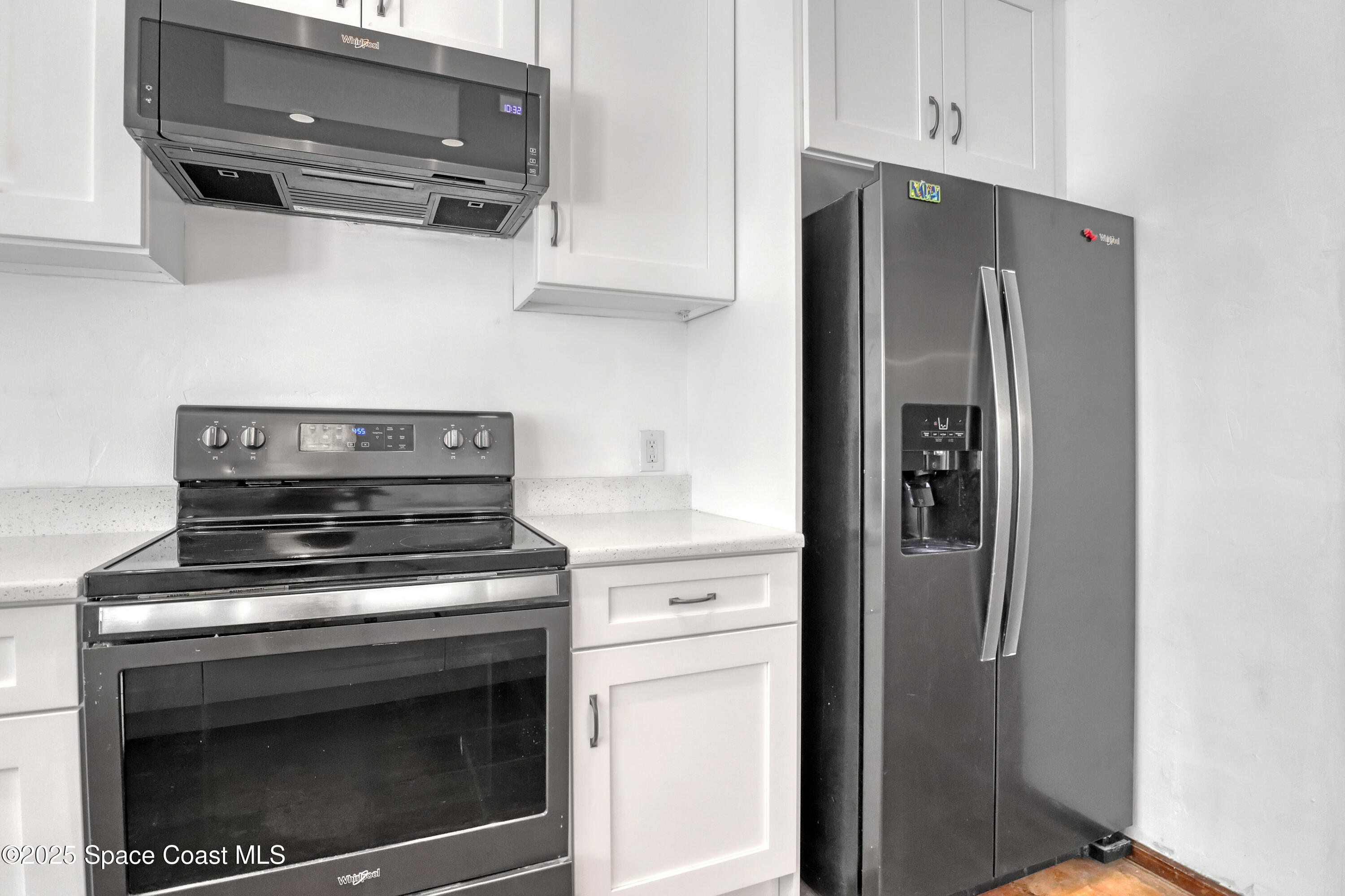 235 Sand Dollar Road Indialantic, FL 32903 - Photo 25 of 64 a kitchen with stainless steel appliances white cabinets and a refrigerator
