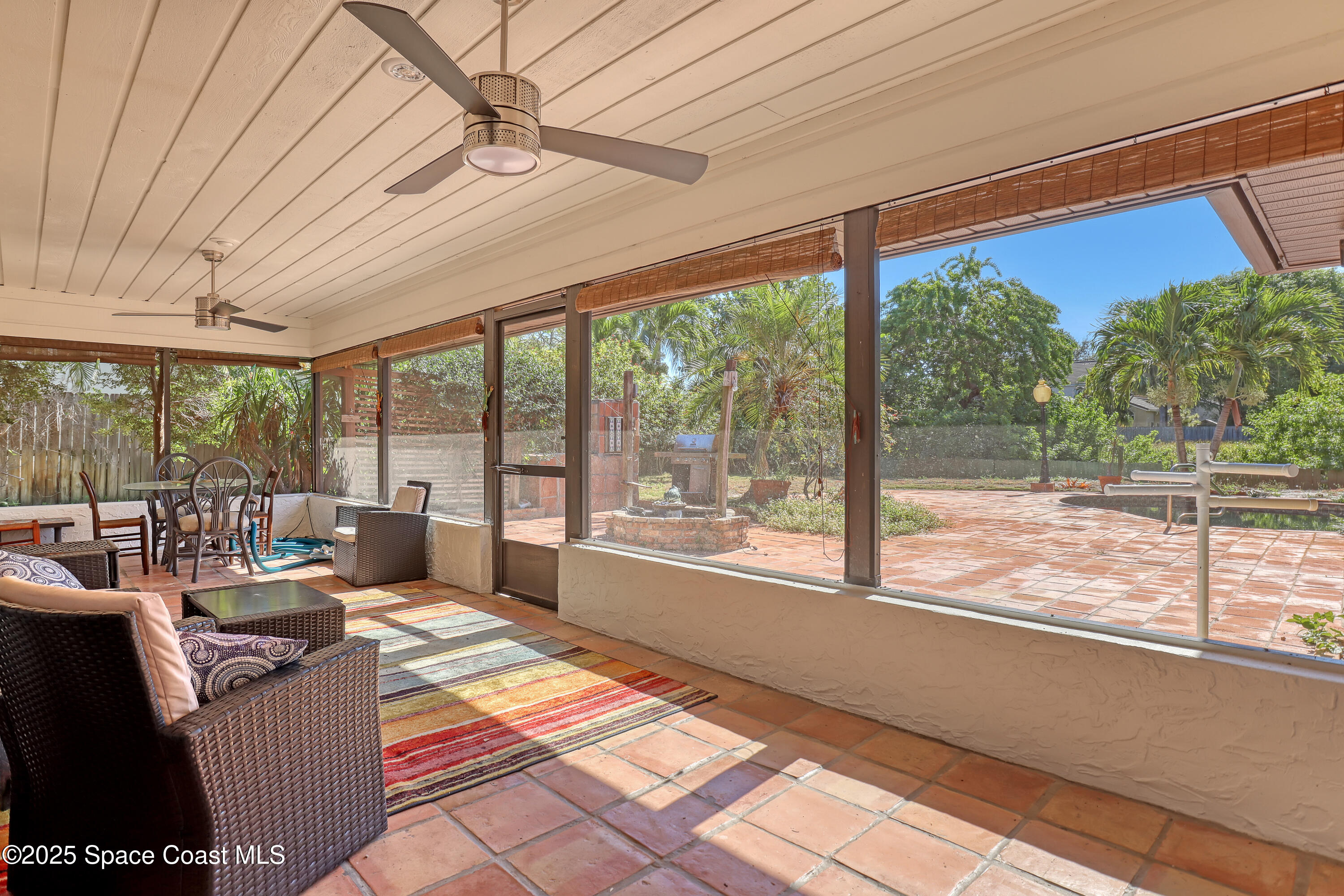 235 Sand Dollar Road Indialantic, FL 32903 - Photo 43 of 64 a living room with furniture and a floor to ceiling window