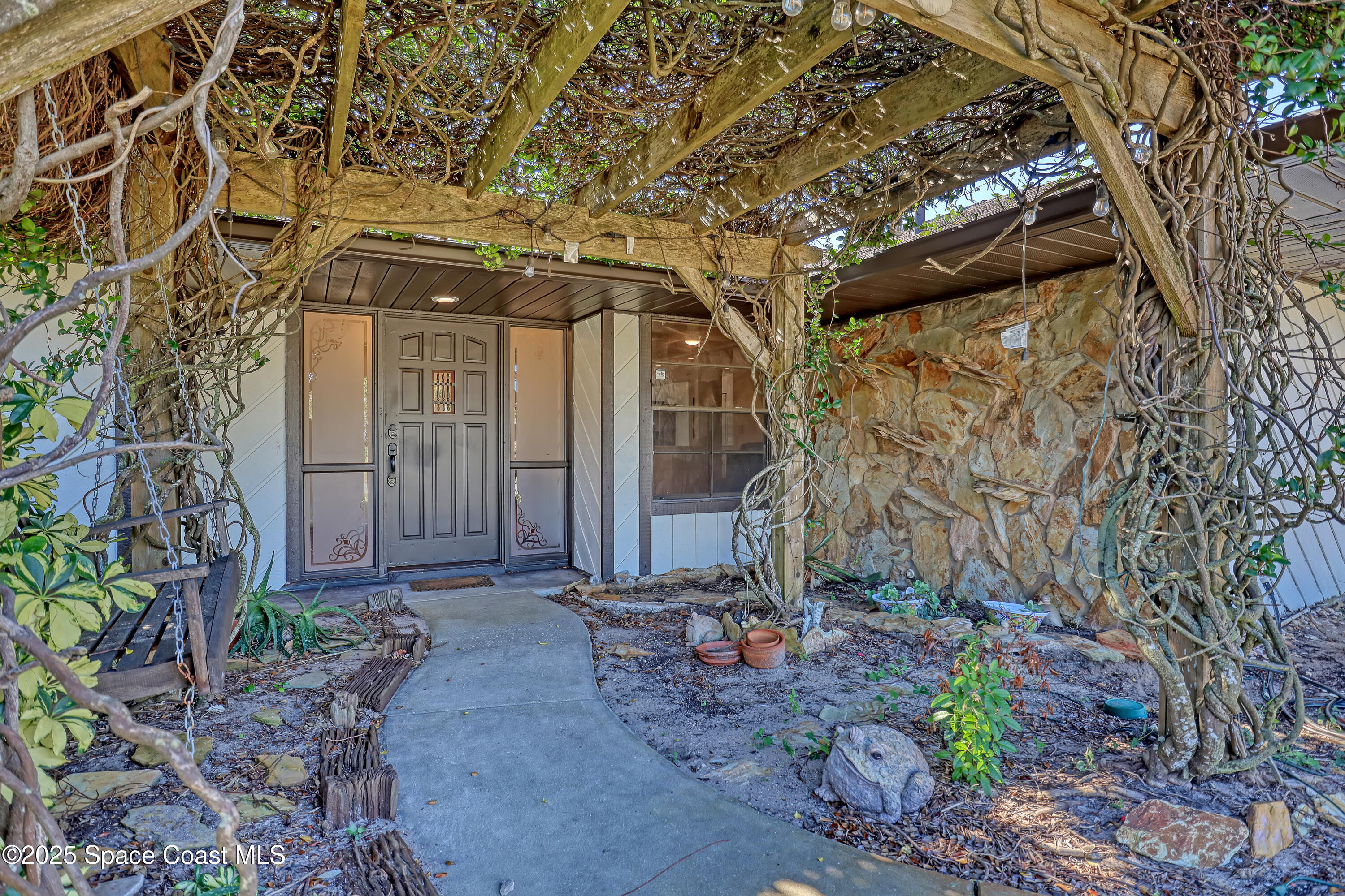 235 Sand Dollar Road Indialantic, FL 32903 - Photo 5 of 64 a front view of a house with garden