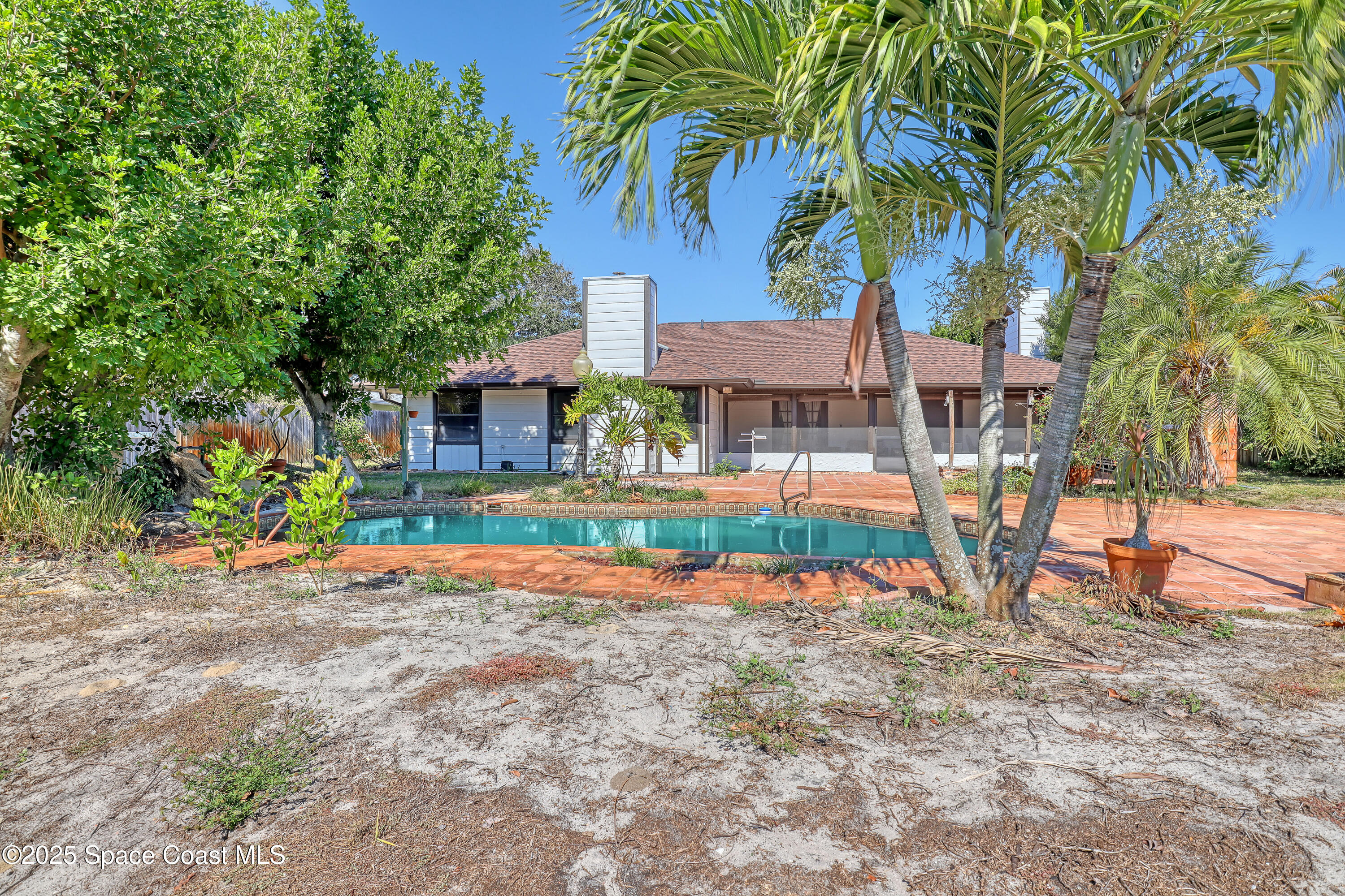 235 Sand Dollar Road Indialantic, FL 32903 - Photo 52 of 64 front view of a house with a yard and potted plants
