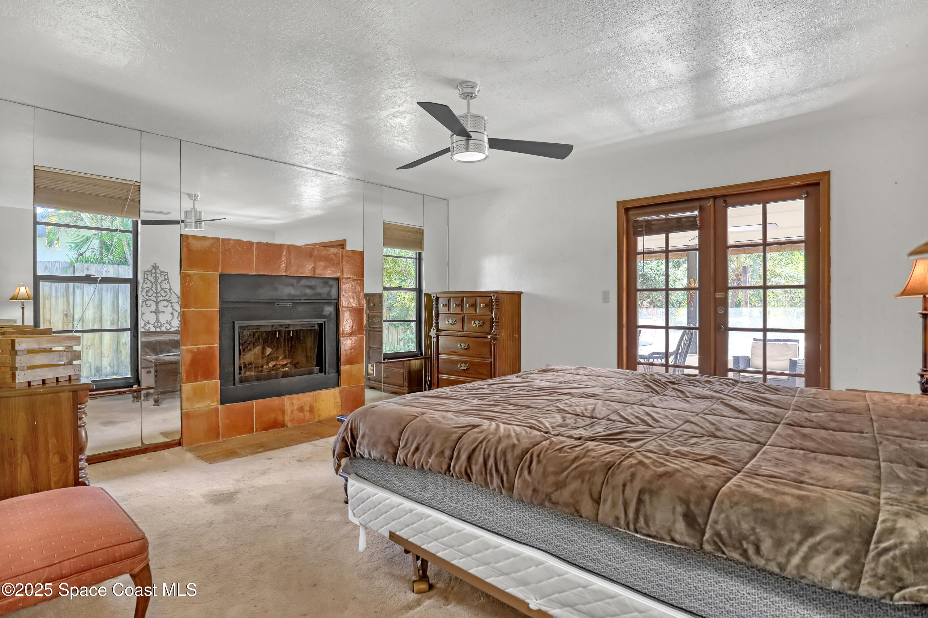 235 Sand Dollar Road Indialantic, FL 32903 - Photo 9 of 64 a bedroom with a balcony a bed and a fireplace