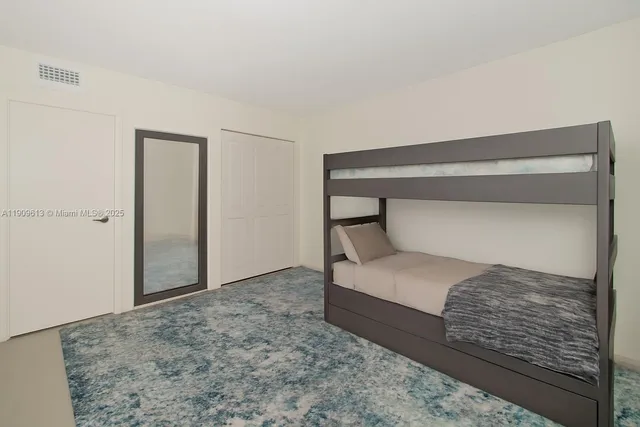 a bedroom with a bed and pillows