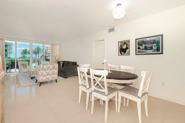 a view of a dining room with furniture and a floor to ceiling window