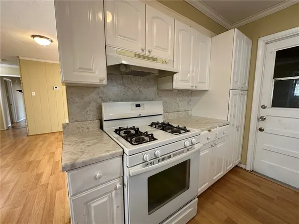 a kitchen with stainless steel appliances white cabinets and a stove
