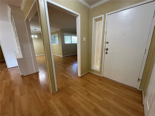wooden floor in a hallway with a glass door