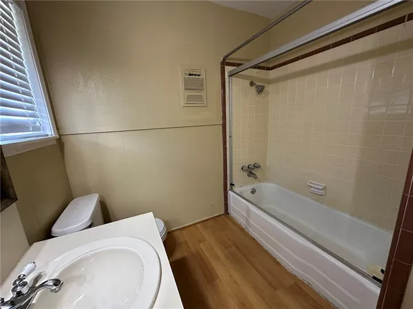 a bathroom with a bathtub and a toilet