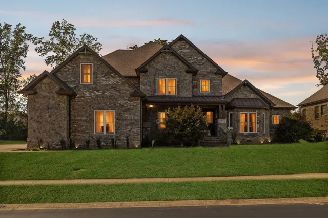 a view of a brick building next to a yard