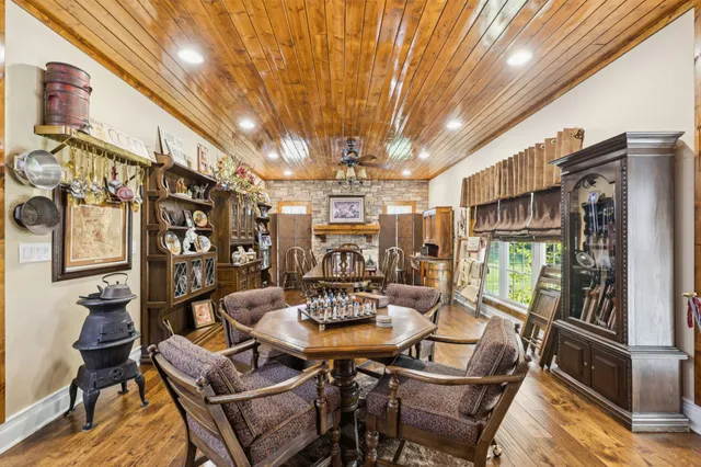 a view of a dining room with furniture a chandelier and wooden floor