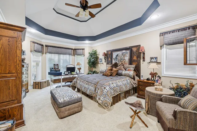 a bedroom with a bed a couch and dresser