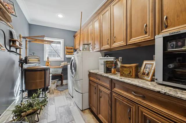a room with stainless steel appliances granite countertop a refrigerator and a stove top oven